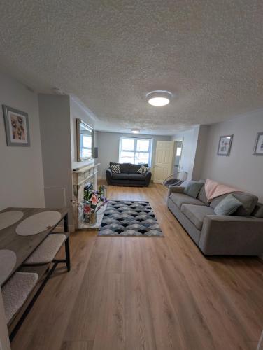 a living room with a couch and a fireplace at Fountain Street in Bessbrook
