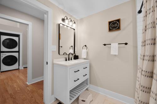 a white bathroom with a sink and a mirror at Buckeye Lake Cottage in Buckeye Lake