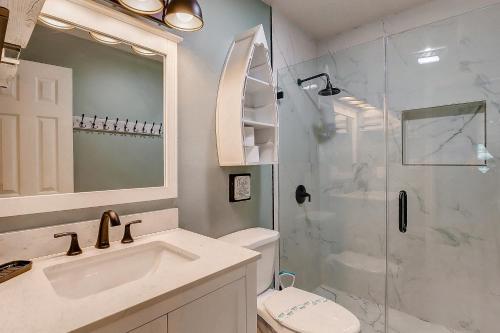 a bathroom with a shower and a sink and a toilet at Blue Heaven by Bolivar Escapes in Crystal Beach