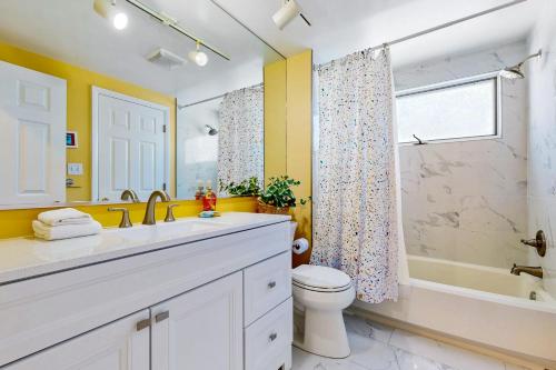 a bathroom with a sink and a toilet and a shower at Sea Colony --- 16004 Bayberry Court in Bethany Beach