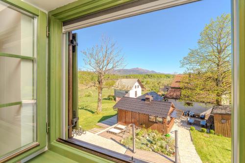 a window with a view of a barn at Tesla's Gastro House Plitvice in Plitvička Jezera