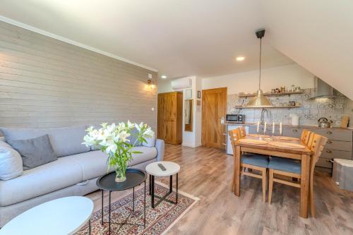 a living room with a couch and a table at Tesla's Gastro House Plitvice in Plitvička Jezera
