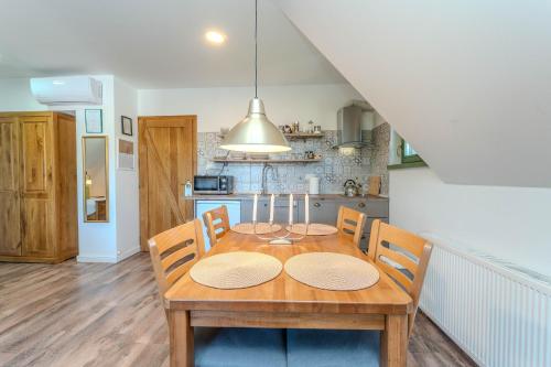 a dining room table and chairs in a kitchen at Tesla's Gastro House Plitvice in Plitvička Jezera