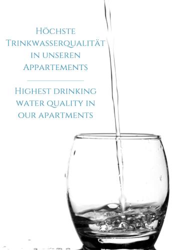 a wine glass filled with water on a white background at Das Alpenzeit Appartement mit Just Private Terrasse in Bad Aussee