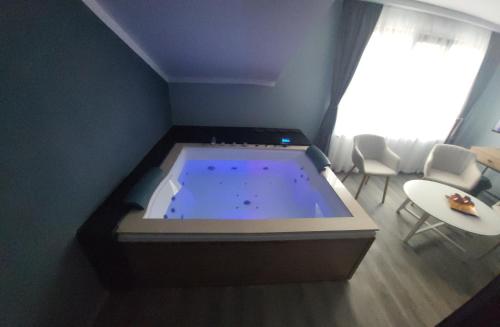 a large jacuzzi tub in the corner of a room at Pensiunea Hanul Huniazilor HD in Hunedoara