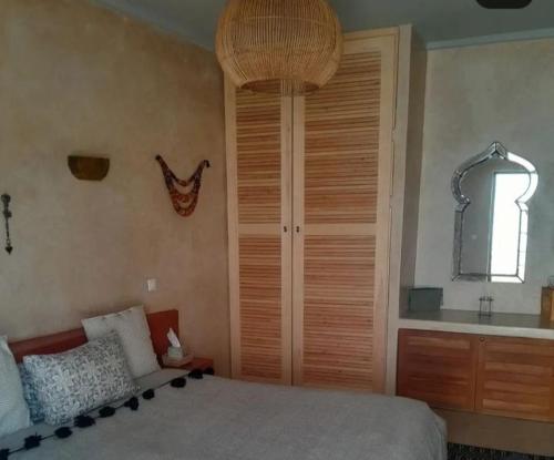 a bedroom with a bed and a window and a sink at Riad Azama in Azemmour