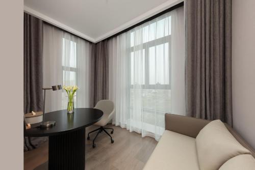 a living room with a table and a large window at Atour Hotel Nantong Development Zone Aeon Mall in Nantong