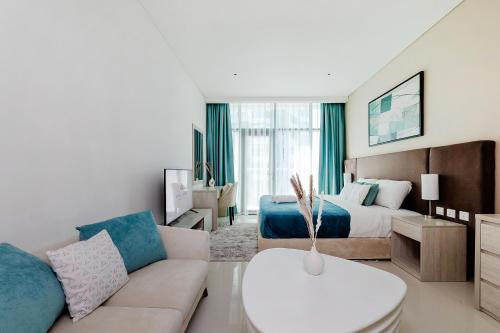 a living room with a bed and a couch at Popular Seven Palm Apartments in Dubai