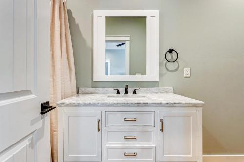 a bathroom with a white sink and a mirror at Sea You Soon in Port Bolivar
