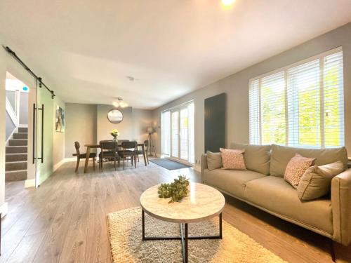 a living room with a couch and a table at Wanderdown House near the Beach with ample Free Parking in Rottingdean