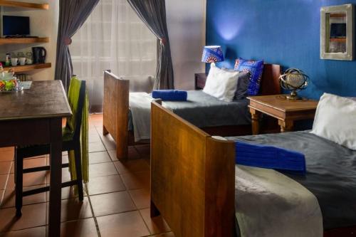 a room with two beds and a kitchen with a table at Hilton Castle in Hilton