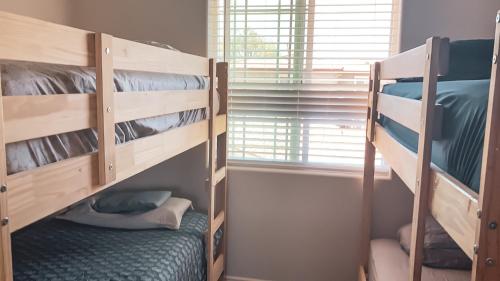 two bunk beds in a room with a window at Orange County Homes in Santa Ana