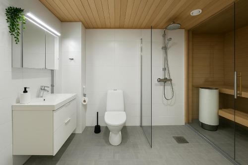 a bathroom with a shower and a toilet and a sink at City Home Finland Big Luxury Suite - Spacious Suite with Own SAUNA, One Bedroom and Furnished Balcony next to Train Station in Tampere