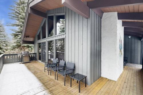 a deck with chairs and a grill on a house at Sun Valley Alpenglow in Ketchum