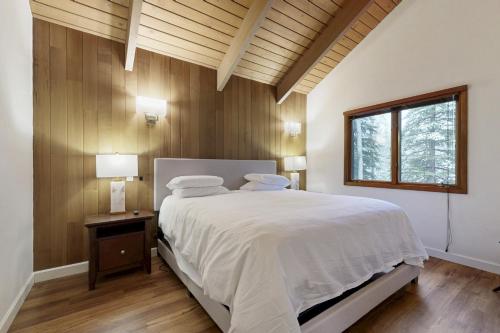 a bedroom with a white bed and a window at Sun Valley Alpenglow in Ketchum