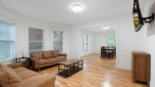 a living room with a couch and a table at 6 bedroom House Short Walk to Niagara Falls in Niagara Falls