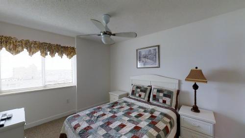 a bedroom with a bed and a ceiling fan at Laguna Keyes Unit 1211 in Myrtle Beach