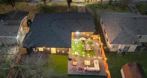 an aerial view of a house with a backyard at night at Fun-Filled Backyard Firepit Grill Games Good Vibes in Houston