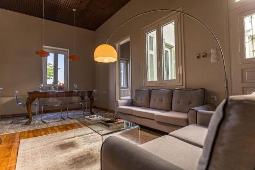 a living room with a couch and a table at Acropolis 360 Residence,2 bedr in Athens