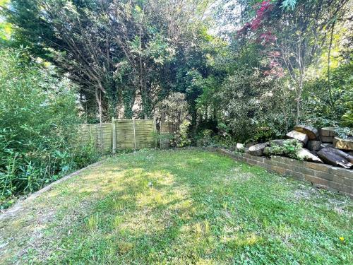 a backyard with a fence and a grass yard at Wanderdown House near the Beach with ample Free Parking in Rottingdean