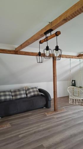 a living room with a black couch and a table at Maki Village in Bukorovac