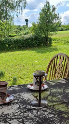 a table with two cups of coffee on top of it at Maki Village in Bukorovac
