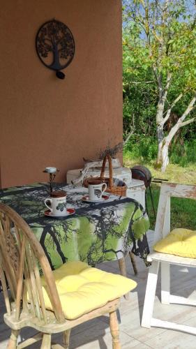 a table and chairs with tea cups on a patio at Maki Village in Bukorovac