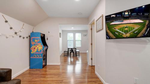 a living room with a tv on a wall at 7 Bedroom House! Walk to Niagara Falls! New Whole House in Niagara Falls