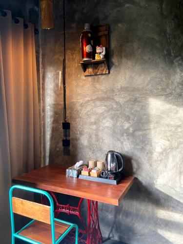 a wooden table with a tea kettle on a wall at Sawah Ijen in Licin