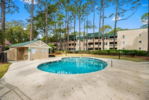 a swimming pool with a building in the background at The Spa 1115 in Hilton Head Island