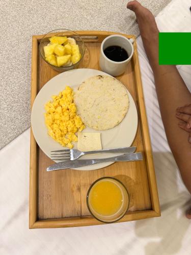 a tray of food with a plate of breakfast food at Hotel y Cabañas Covemar in Coveñas