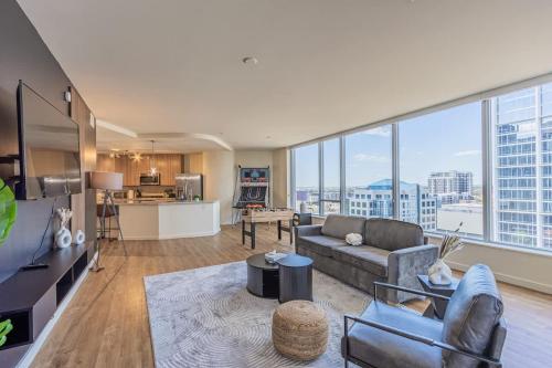 a living room with a couch and a large window at 1BR Modern Apartment in DT HighRise with Gym, Parking, Pool and W-D in Phoenix