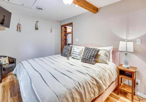 a bedroom with a bed and a table with a lamp at Lake Milton 1 Block From Beach With A Hot Tub in Lake Milton