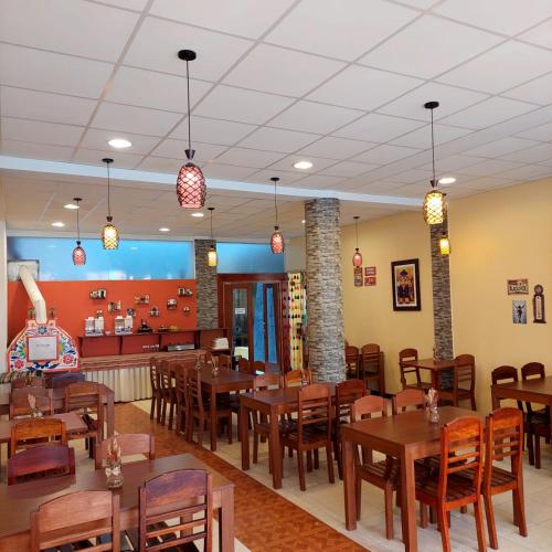 a dining room with wooden tables and chairs at Hotel Munay Tambo in Puno