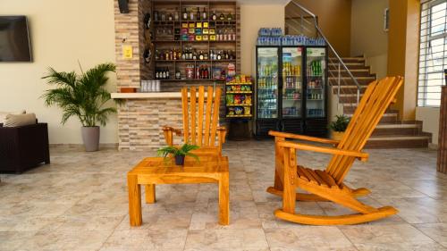 two wooden chairs and a table in a store at Hotel y Cabañas Covemar in Coveñas