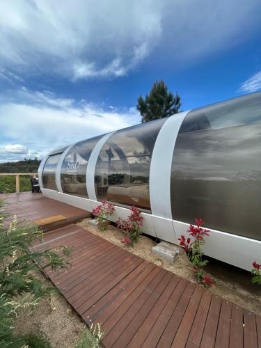 a train is parked on a wooden deck with flowers at SKD Casa Naranja Suite Rioja in Avila