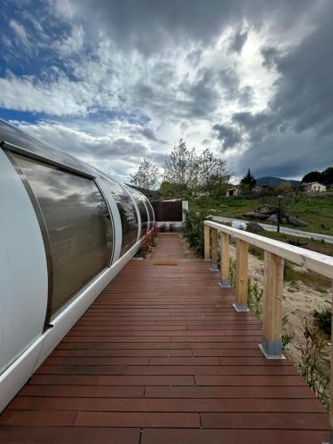 a train on a wooden walkway next to a bridge at SKD Casa Naranja Suite Rioja in Avila