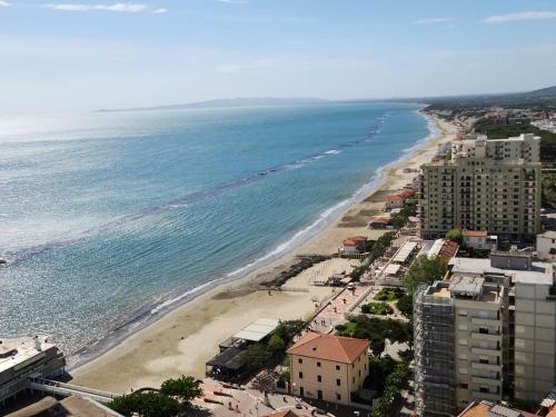 an aerial view of a beach with buildings and the ocean at Suite Torre Azzurra B&B - Rooftop Sea View in Follonica