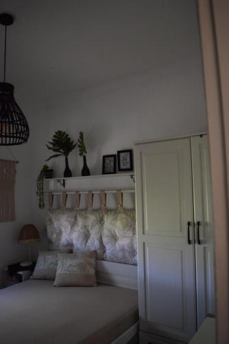 a bedroom with a white bed and a white cabinet at Dimitris house in Paralía Avdhíron