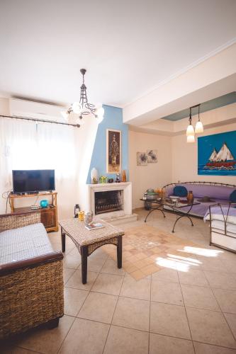 a living room with a couch and a fireplace at Villa Sapphire BeachFront Eretria in Eretria