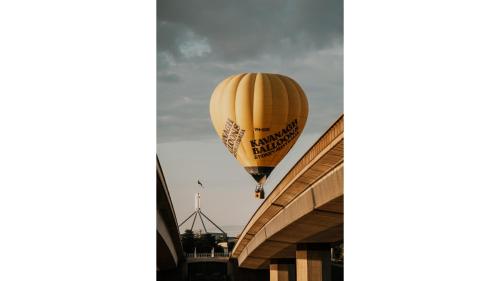 a hot air balloon is flying over a building at Edgar at Lake George Winery at Tiny Away in Collector