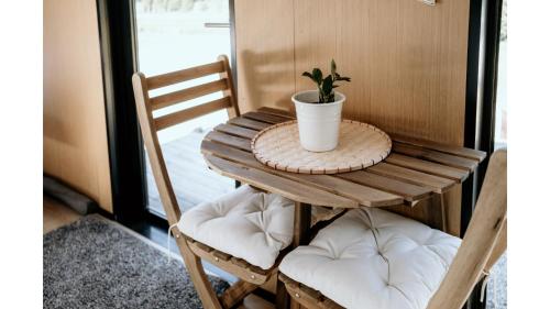 a small wooden table with a potted plant on it at Edgar at Lake George Winery at Tiny Away in Collector