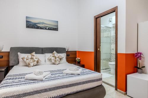 a bedroom with a bed with towels on it at STELLA GUEST HOUSE O AFFITTACAMERE in Rome