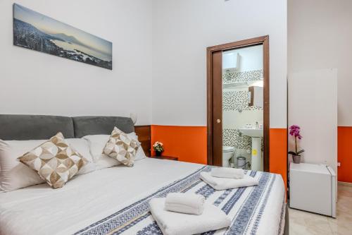 a bedroom with a large white bed with pillows at STELLA GUEST HOUSE O AFFITTACAMERE in Rome