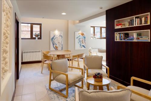 a living room with a table and chairs at Hotel Ribadesella Playa in Ribadesella