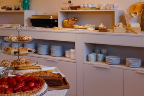 a bakery with a table with bread and fruit on it at Hotel Ribadesella Playa in Ribadesella