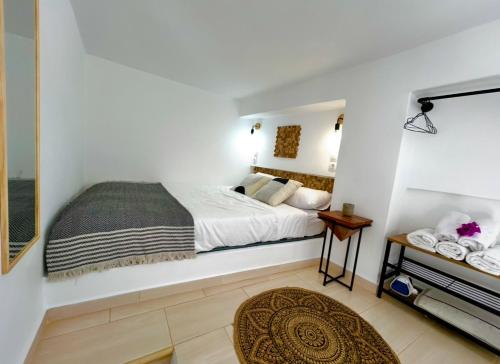 a bedroom with a bed in a white room at Babatseratsi skyrian studio 1 in Skiros