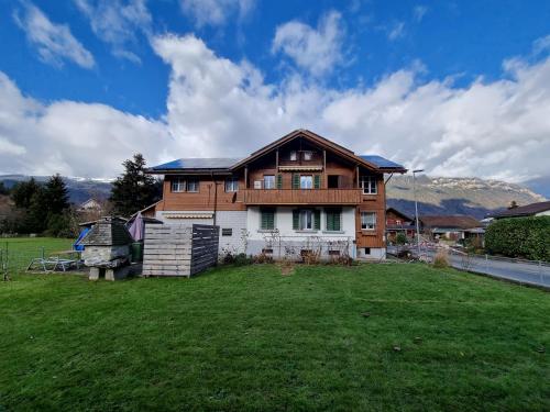une maison avec une grande cour devant elle dans l'établissement Family-friendly apartment with Alpine view, à Matten