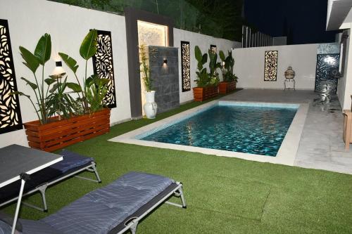 a swimming pool in the middle of a yard at Luxurious Stella 2-bedroom Apartment with Pool in Hammamet Nord