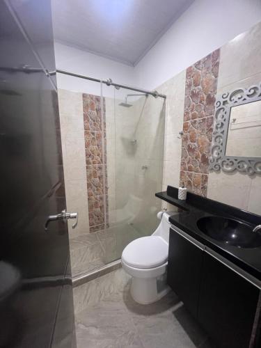 a bathroom with a shower and a toilet and a sink at Finca Hotel Villa el Ocaso Huila in Rivera